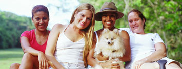 Photo: Four women and a dog.