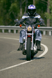 A man wears a helmet while riding a motorcycle.