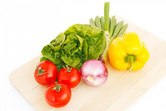 Tomatoes, lettuce, celery and a pepper on a cutting board.