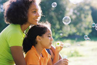 Photo: Mother and daughter blowing bubbles