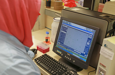 Technician reads cell counts on monitor