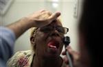 Rachel Lowe, 50, has her throat examined as part of a street medicine program between Venice Family Clinic and St Joseph Homeless Day Center in Venice, Los Angeles, California, February 16, 2011. REUTERS/Lucy Nicholson