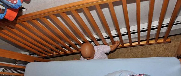 crib with loose side pushed against wall