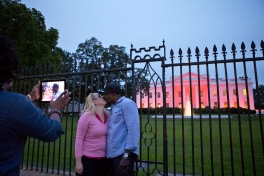 Tourists have their picture taken in front of the White House, Oct. 1, 2012. The North Portico of the White House is illuminated pink in honor of Breast Cancer Awareness Month. (Official White House Photo by Sonya N. Hebert)