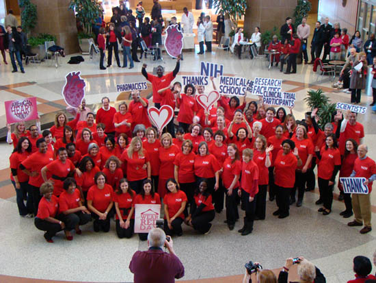 Group of NIH staff posing for a photo with thank-you signs