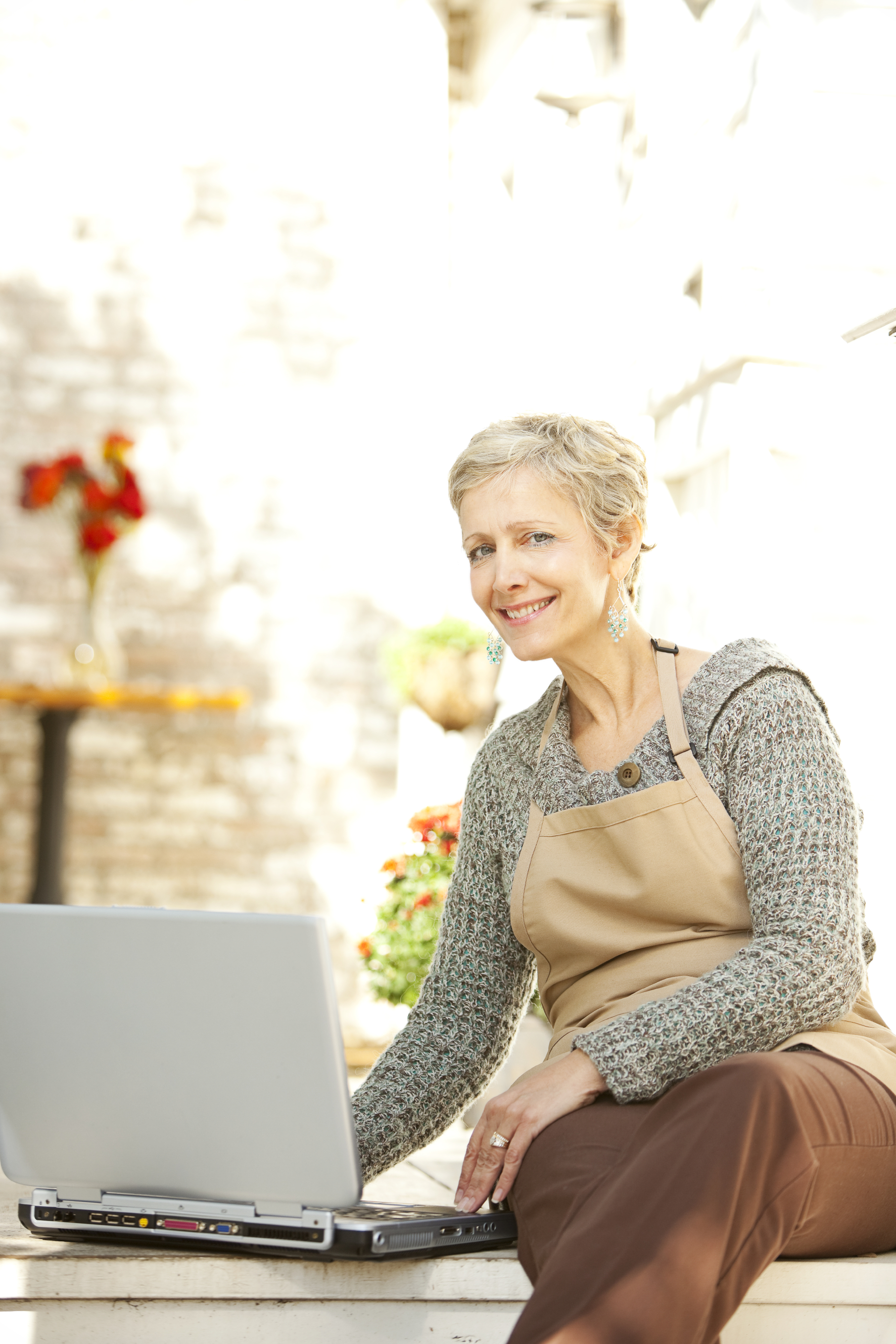 Woman sitting outside in front of a laptop