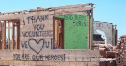 building destroyed by Joplin tornado with thank you sign success story thumbnail
