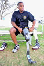 A photograph of a male athlete with a leg prosthesis