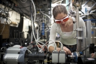 NREL researcher Kirsten Alberi works in the luminescence mapping laboratory at the Solar Energy Research Facility (SERF). Here she aligns a laser and sample to map the photoluminescence coming off the sample. | Photo by Dennis Schroeder, NREL.