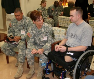 A Service member speaks with his nurse-case manager and platoon leader at a clinic. (Photo courtesy of the U.S. Army) 