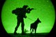 As seen through a night-vision device, Marine Corps Lance Cpl. Sam Enriquez, and his K-9 partner Kally, take part in night operations training during the Inter-service Advanced Skills K-9 course, at the U.S. Army's Yuma Proving Ground, Ariz., Sept. 25, 2012. Enriquez, a military working dog handler, is assigned to 3rd Law Enforcement Battalion, stationed in Okinawa, Japan.  U.S. Marine Corps photo by Cpl. Aaron Diamant