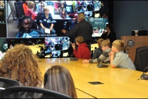 Administrator Craig Fugate answers questions from children via video-teleconference for Bring Your Kids to Work Day
