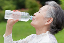 photo of a woman drinking a bottle of water