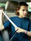 Photo of a young girl fastening her seatbelt
