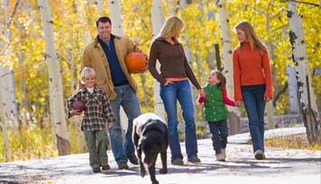 Photo of a family walking their dog