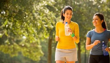Photo of two women taking a walk on their coffee break