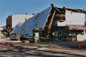 Structures and a vehicle damaged in downtown Paso Robles in the 6.5 San Simeon Earthquake