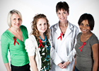 Four women wear HIV/AIDS red awareness ribbons