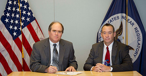 NRC's John Kinneman, (left) director of the Division of Fuel Cycle Safety and Safeguards, with Steve Laflin, (right) president and CEO of International Isotopes, pose for a photo at the license signing ceremony for the depleted uranium deconversion facility in Lea County, N.M.
