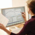 woman analyzing charts on computer screen