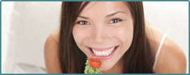 Photo of a young woman eating a salad