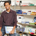 print shop worker with reams of paper