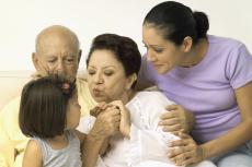 Photograph of a senior couple, a woman and a young girl sitting together