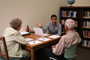 A facilitator from StoryCorps prepares patrons for their interview at the Braille Institute Library Services.