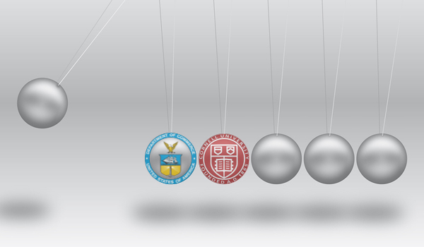 Newton's Cradle with the Department of Commerce seal and Cornell University seal on two of the six silver balls