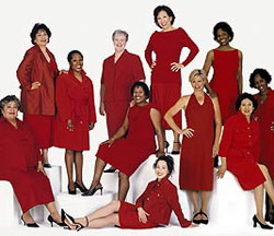 group of women wearing red dresses and smiling
