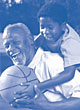 Image of an elderly man is playing basketball with his grandson.