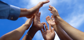group of diverse hands in the air