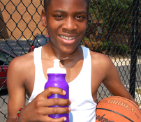Boy holds a basketball and water bottle