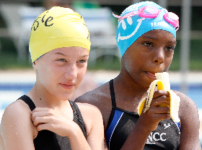 Girls on swim team eat bananas