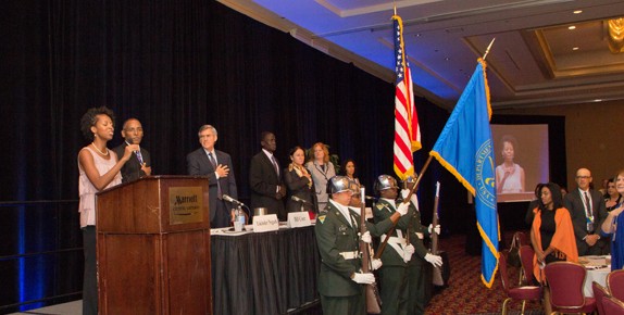 ACF’s Miya Cain sings the National Anthem as the Woodrow Wilson High School Color Guard presents the colors.