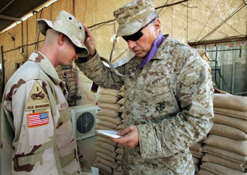 Picture of Chaplain giving Prayer to Solider