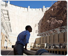 President Obama standing on the transformer deck at Hoover Dam along the Colorado River on October 2, 2012