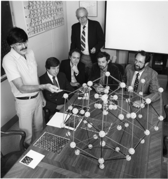 Meeting at the National Institute of Standards and Technology (NIST) in 1985 just months after shaking the foundations of materials science with publication of his discovery of quasicrystals, Daniel Shechtman, winner of the 2011 Nobel Prize in Chemistry, discusses the material’s surprising atomic structure with collaborators.  From left to right are Shechtman; Frank Biancaniello, NIST; Denis Gratias, National Science Research Center, France;  John Cahn, NIST; Leonid Bendersky, Johns Hopkins University (now at NIST); and Robert Schaefer, NIST.