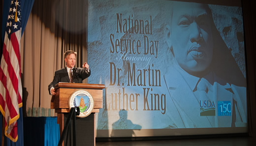 Max Finberg, Director, Faith Based and Neighborhood Partnerships, Master of Ceremonies reads a children’s book of Dr. Martin Luther King’s life to the audience during the National Service Day and Martin Luther King Celebration.