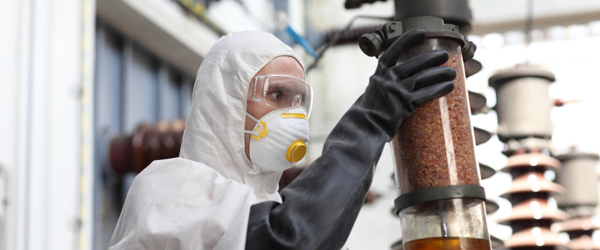 A worker examines radioactive material