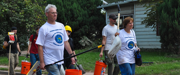 Volunteers in matching t-shirts arrive to aid in disaster clean-up.