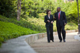 photo of two business people talking while walking outside