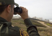 Border patrolman with binoculars