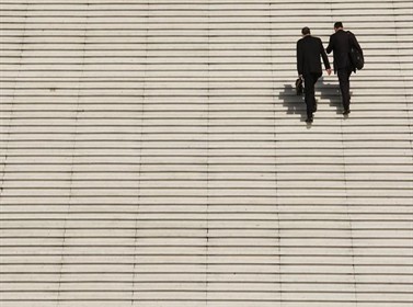 Businessmen with briefcases climbing office building steps, file photo. REUTERS Benoit Tessier