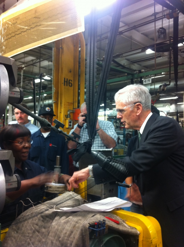 Secretary Bryson asks a worker at Schlegel Systems, Inc. about her machine