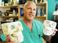 Photo of surgeon Jon Wagner holding plastic casts of fractured jaws.