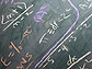 Mathematical equations on chalkboard.