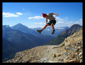 Happy tourist jumping in Glacier National Park