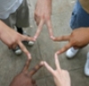 5 people using their fingers to form a star