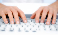 Photo of a hands typing on a keyboard